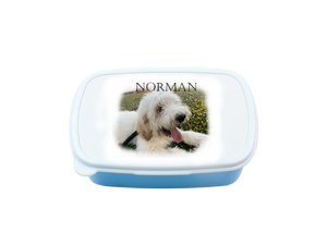 Blue lunch box with white lid and photo of dog and his name