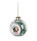 Clear round ornament with green ribbon inside and photo of dog