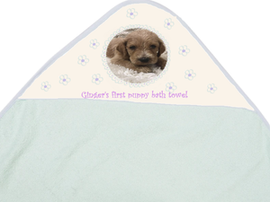 Hooded puppy towel with photo of puppy and "Ginger's first puppy bath towel"